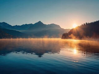 Fototapeta premium Sunrise over a serene lake reflecting the mountains