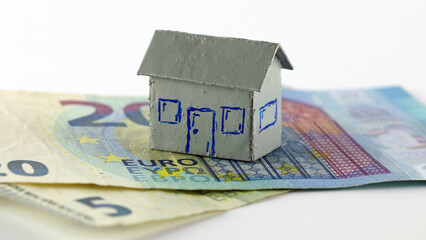 This is a model of a detached house, as well as some banknotes from the European Union