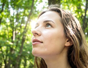 Woman looking upwards in a forest