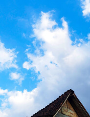 Blue sky with clouds and traditional roof | Langit biru dengan awan dan atap rumah tradisional