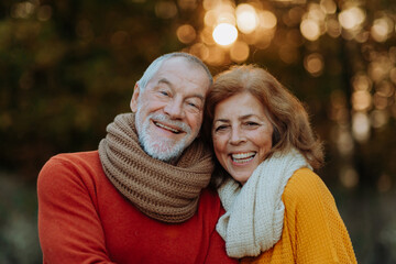 Portrait of senior couple in autumn nature.