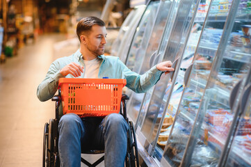 Customer with disability choosing frozen food in supermarket refrigerator