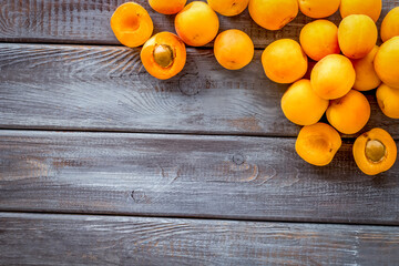 Fruit background with apricots on dark wooden background top view copy space