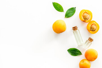 Fruit aroma oil. Apricot kernel oil on white background top view frame space for text