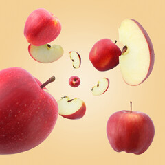 Fresh red apples swirling in air against beige gradient background