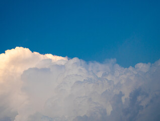 Dramatic clouds against a bright blue sky, creating a stunning natural scene.