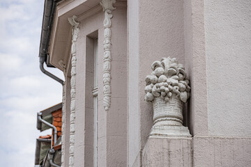 Detailed stone ornament with fruit basket sculpture on historic building facade