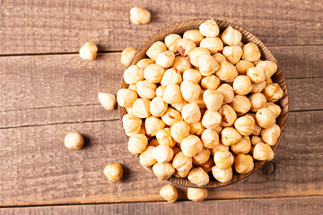 Organic hazelnuts in a wooden bowl. Vegan food concept. 