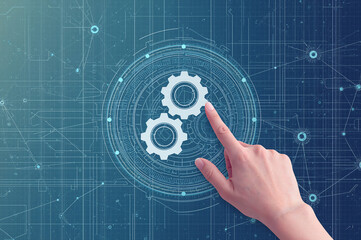 Human finger touching digital gears on a futuristic blue interface with circuit patterns technology