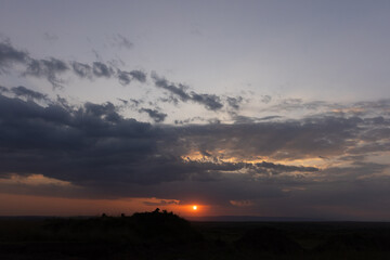 Silhouette of lion and dramatic sunset at Masai Mara, Kenya