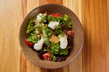 Enjoy a Fresh and Colorful Garden Salad with Delicious Toppings in a Rustic Bowl