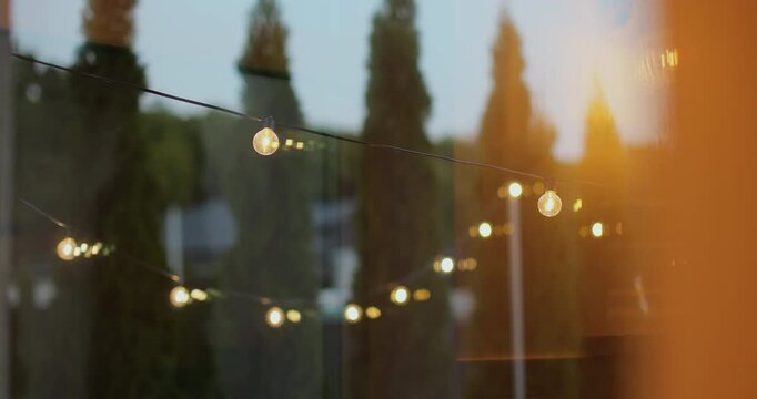 Decorative lights in the backyard of the house. Garden decoration. Party camping.