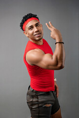 Naklejka premium Young fitness trainer with a positive attitude, healthy athletic man wearing a red T-shirt. Sports concept