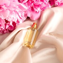 Elegant perfume bottle on blush satin with peonies