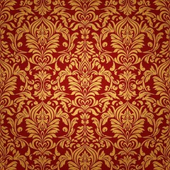 A detailed gold damask pattern with an ornate relief design is on a clean red surface. The texture is a piece of decorative and elegant wallpaper. Seamless repeatable texture.