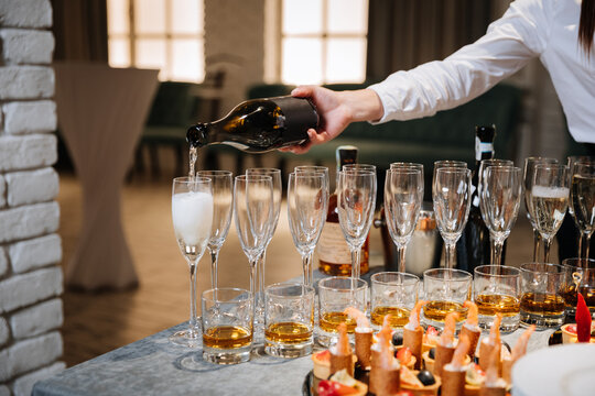 Champagne being poured into glasses during elegant catering event celebration
