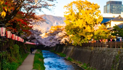 A tranquil stream flows through a city, lined with autumnal trees and cherry blossoms, lanterns hang overhead