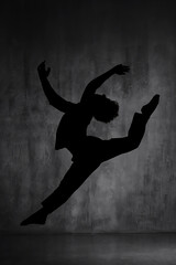 Silhouette of Dancer with Arms and Legs Outstretched