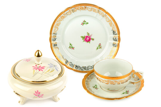 Vintage sugar bowl, tea cup, and plate with gold trim and floral patterns - Powered by Adobe