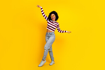 Young Woman Expressing Joy with Stylish Casual Attire Against a Bright Yellow Background Showcasing...
