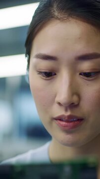 Ecu dolly video: diverse professional's face, furrowed brow, intense concentration in blurred modern lab, soft light, bokeh. Concept of focused problem-solving