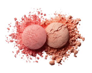 Two light pink and peach eyeshadow/blush compacts nestled in a burst of scattered powder