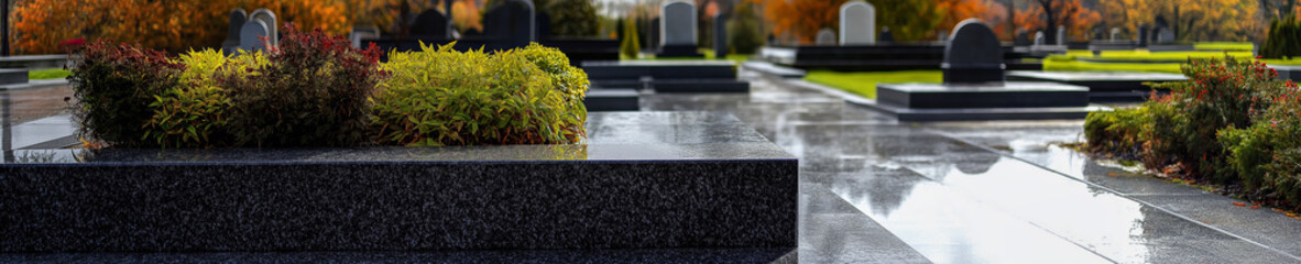 Modern cemetery with polished granite tombstones and neatly arranged greenery. A tranquil and dignified place for remembrance and reflection.