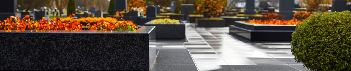 Polished granite tombstones in a tidy and well-kept cemetery with lush greenery. A tranquil and respectful place for remembrance.
