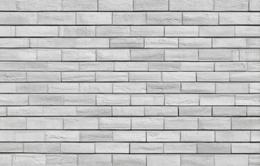 Naklejka premium A close-up view of a light gray brick wall. Rows of rectangular bricks, evenly spaced, create a seamless, repeating pattern. 