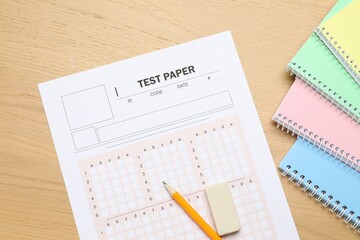 Answer sheet, eraser, pencil and notebooks on wooden table, flat lay. Student passing exam