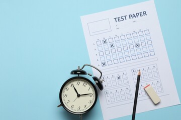 Student passing exam. Answer sheet, alarm clock, pencil and eraser on light blue background, flat...