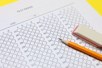 Answer sheet, pencil and eraser on table, closeup. Student passing exam