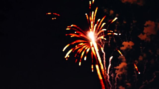 Blurred Orange Pyrotechnic Illuminations On Dark Nocturnal Backdrop