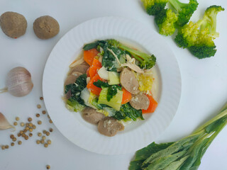 Capcay is a typical Chinese-Indonesian dish consisting of various types of vegetables cooked by boiling or stir-frying. Separated on a white background.