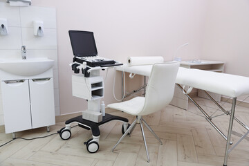 Modern ultrasound machine and examination bed in clinic
