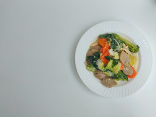 Capcay is a typical Chinese-Indonesian dish consisting of various types of vegetables cooked by boiling or stir-frying. Separated on a white background.