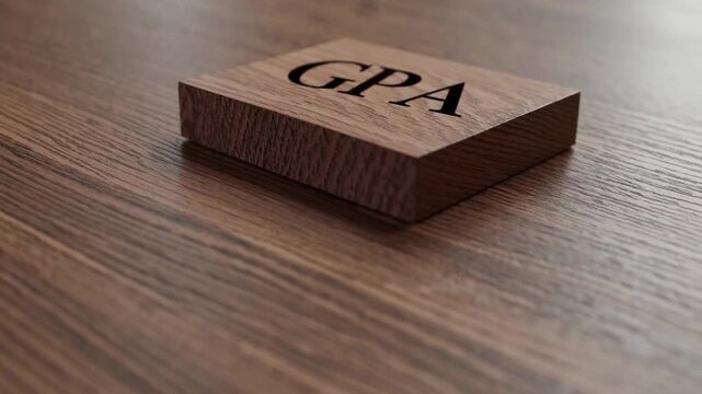 cubed piece of timber inscribed with the acronym representing academic performance measurement