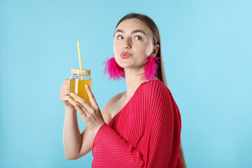 Woman with refreshing drink and straw on light blue background