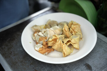 Siomay in the pan and ready to be sold. Siomay are fish cake dumplings with potatoes, eggs and rolled cabbage served with peanut sauce and chili. Siomay is a traditional Indonesian culinary food.
