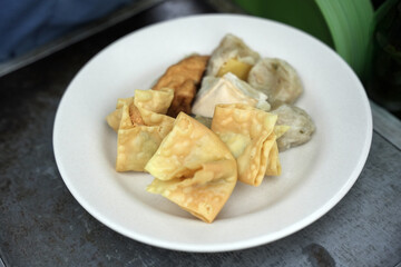 Siomay in the pan and ready to be sold. Siomay are fish cake dumplings with potatoes, eggs and rolled cabbage served with peanut sauce and chili. Siomay is a traditional Indonesian culinary food.