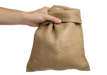 Hand holding brown burlap sack isolated on transparent background