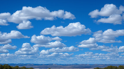 Clouds shaped from blue energy drift lazily across a vast prairie sky over rolling hills wildflowers herds of bison grazing and a lone windmill spinning in the distance shown
