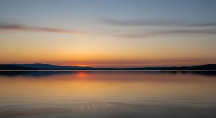 Obraz premium Sunset over a Calm Lake.