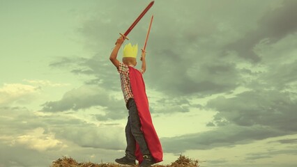 happy family. little boy playing with ball sunset wearing golden paper crown. chidhood dream. kid...