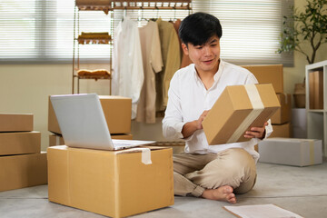 A young business owner is checking the boxes to deliver to customers before shipping them.