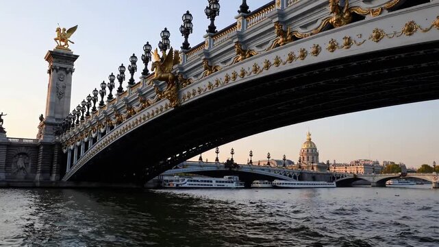 famous ornate bridge spanning river in major European capital city, with view towards military museum and imperial burial site