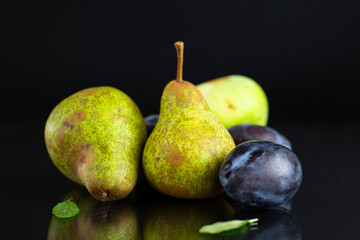 Natural fresh pears and plums in macro photography