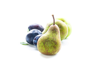 Delicious pears and ripe plums close-up