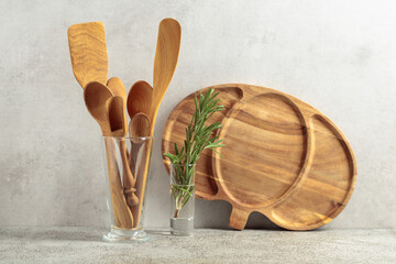 Wooden kitchen utensils and rosemary.