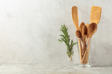 Wooden kitchen utensils and rosemary.